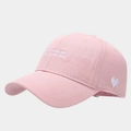 Close-up of pink cotton baseball cap with white heart embroidery and side letter stitching - Adjustable / Pink