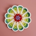 Handmade crochet flower coaster in multi-color gradient design with soft white plush edge - No. 11 Gradient