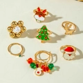 Close-up of Christmas ring set featuring gold elk, Santa, and tree designs in colorful enamel - Christmas 7-Piece Set (20890-1)
