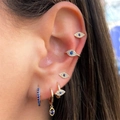 Gold evil eye earring set featuring blue zircon studs and cuffs on a model ear - Evil Eye Earring Set A-TZ00054 Gold