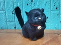 Realistic black plush cat toy with blue eyes, red collar, and golden bell detail - Black Chubby Cat With Sound