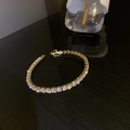 Classic tennis bracelet with AAA cubic zirconia in gold-tone setting on black surface - 4# Bracelet-Gold-Round Single Row Style
