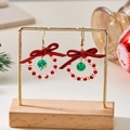 Christmas bow wreath earrings with red velvet ribbons and green crystal beads on a gold stand - Style 5 (Red Bow Red White Wreath Green Drop)