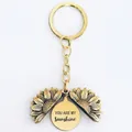 Macro shot of sunflower keychain showing You Are My Sunshine engraving on inner metal plate - T00001 Full Gold (You are my sunshine)