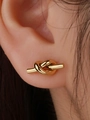 Minimalist knot design stud earrings in golden finish shown on a female ear model - Gold