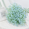 Single bouquet of light blue artificial baby's breath flowers on white fabric backdrop - Medium Blue