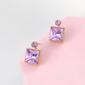 Detail of square purple gemstone earrings with gold setting on a pink display stand - Deep Violet