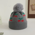 Close-up of thick ribbed knit texture with cherry pattern and fluffy pompom on winter hat - 1-3 Years / Gray