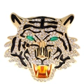 Golden tiger head brooch with sparkling rhinestones and green eyes on white background - Gold