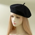 Classic black wool cashmere-like beret hat shown on model for a retro British style - One Size / Black