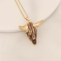 Close-up of bohemian bull skull pendant with brown texture and gold-plated horns - Brown Faux Bone Gold Horn Bull Head (13#)