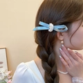 Blue satin bow hair clip with central pearl cluster worn by a model in soft light - 40# Duckbill Clip - Blue - Blue Bowknot Pearl Style