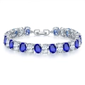 Macro shot of silver tennis bracelet featuring alternating blue and white oval gemstones - Platinum Dark Blue