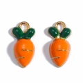 Close-up of orange carrot alloy pendants with green leaves for DIY jewelry making - 3D Carrot