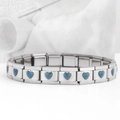 Macro view of stainless steel Italian charm bracelet with a blue heart module - Heart-Transparent Deep Brown (18 Links)