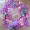 Purple Hawaiian flower crown with LED fairy lights on soft white mesh background - Purple