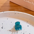 Mini transparent blue plastic hair claw with gold FRANCE Handmade text on a white plate - Dark Green