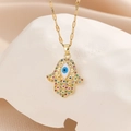 Makroaufnahme der Hamsa-Hand-Halskette in Gold mit buntem Zirkon-Teufelsauge-Anhänger - Gold Bunte Zirkonia Blau Emaille