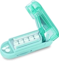 Detail view of mint green pill cutter with multi-slot tray and sharp metal blade - Green
