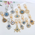 Evil eye and Hamsa hand keychains in gold and silver metal with sparkling rhinestones - 13-Piece Set