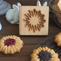 Square beechwood cookie mold featuring intricate carved flower pattern on wood surface - Sandwich Firework