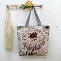 Off-white canvas tote bag featuring dahlia flower prints and striped handles - Purple Flower