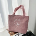 Close-up of pink corduroy tote bag with embroidered cartoon bear drinking milk tea - Sheep Milk Tea Pink