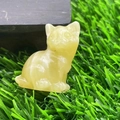 Hand-carved 1.2 inch yellow gemstone kitten figurine with tilted head on green grass - Golden Steatite