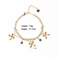 Detailed view of gold double chain bracelet with blue evil eye charms and star pendants - Style 5-Evil Eye Star