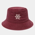 Macro detail of the embroidered white ship wheel logo on the burgundy cotton bucket hat - One Size / Burgundy