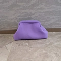 Detail of purple knitted cloud clutch showing the soft woven stripe texture and design - Violet