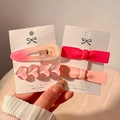 Cute 4-piece pink Y2K hair clip set with hearts and bow shapes on a card - Set of 4 / Peach and Barrette Combo