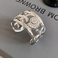 Detail of silver starfish and seashell cutouts on a polished wide cuff bracelet - Starfish Conch Hollow (24#)