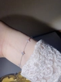 Close-up of S925 sterling silver four-leaf clover bracelet with cubic zirconia on wrist - 925 Silver / White Gold