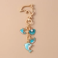 Detail of dolphin keychain with gold metal plating, blue enamel charms, and white pearl bead - Blue Shell