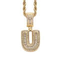 Macro detail of iced-out gold letter U pendant with baguette-cut and round cubic zirconia - Letter U Gold + 60cm Rope Chain