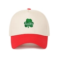Close-up of green clover embroidery with lucky text on red and cream trucker hat - Adjustable / Off-white and Red