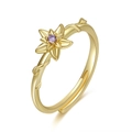 Detailed view of adjustable gold flower ring with a centered purple round zircon stone - December