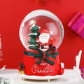 Close-up of a Christmas snow globe with Santa and a tree on a red Merry Christmas base - 80 Medium Music+Light / Christmas Tree Santa