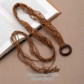 Detail view of woven bohemian belt with tassels placed on an open book for vintage style - Light Coffee Woven Round Buckle Belt (X492-4)