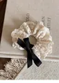 Elegant beige embroidered lace scrunchie featuring a black satin bow and floral texture - Beige Lace with Black Ribbon Scrunchie