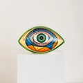 Artistic ceramic Evil Eye ornament featuring colorful geometric patterns on a white pedestal - Yellow Green Style B
