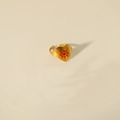 Detailed close-up of golden heart-shaped open ring with red sun pattern on beige background - Sunflower Style (W319太阳花)