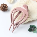 Pink matte plastic hair claw clip with cutout design displayed with natural decor - Glossy Pink