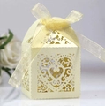 Close-up of laser-cut heart pattern wedding candy box with cream ribbon bow detail - Platinum