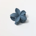 Macro detail of large matte blue frangipani hair claw clip showing petals and teeth - Matte Gray Blue