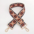 Close-up of ethnic geometric jacquard strap with light gold metal lobster clasps - Dark Blue Orange Floral