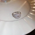 Detailed macro view of wide silver ring with pavé-set zircons on white plate - Silver Eye Shape (14#)