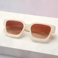 Detail view of stylish cream-white thick frame sunglasses with brown gradient lenses - Off-white Gradient Tea Lens
