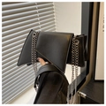 Detail view of black geometric leather bag with silver metal chain straps - Black